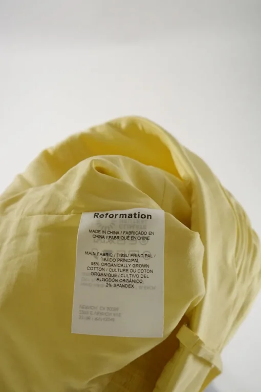 Yellow organic cotton-blend draped foldover bustier top with smocked back and adjustable spaghetti straps