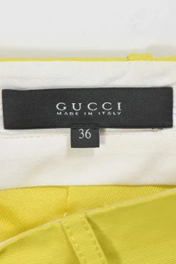 Yellow polyester-blend belted mini skirt featuring darted slant pockets