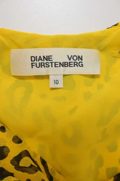 Yellow silk leopard print plunge neck cold-shoulder blouse with cascade ruffle trim appliqué