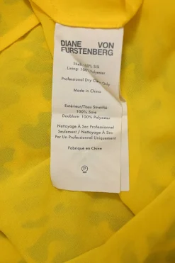 Yellow silk leopard print plunge neck cold-shoulder blouse with cascade ruffle trim appliqué